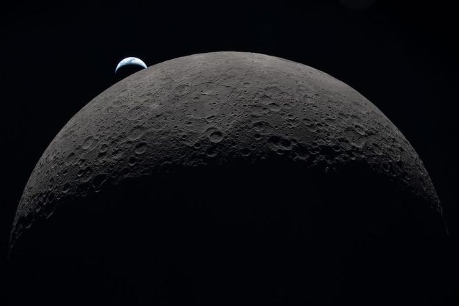 Earth Set Image from Artemis II showing the moon in foreground and waning crescent earth above and to the left of the moon